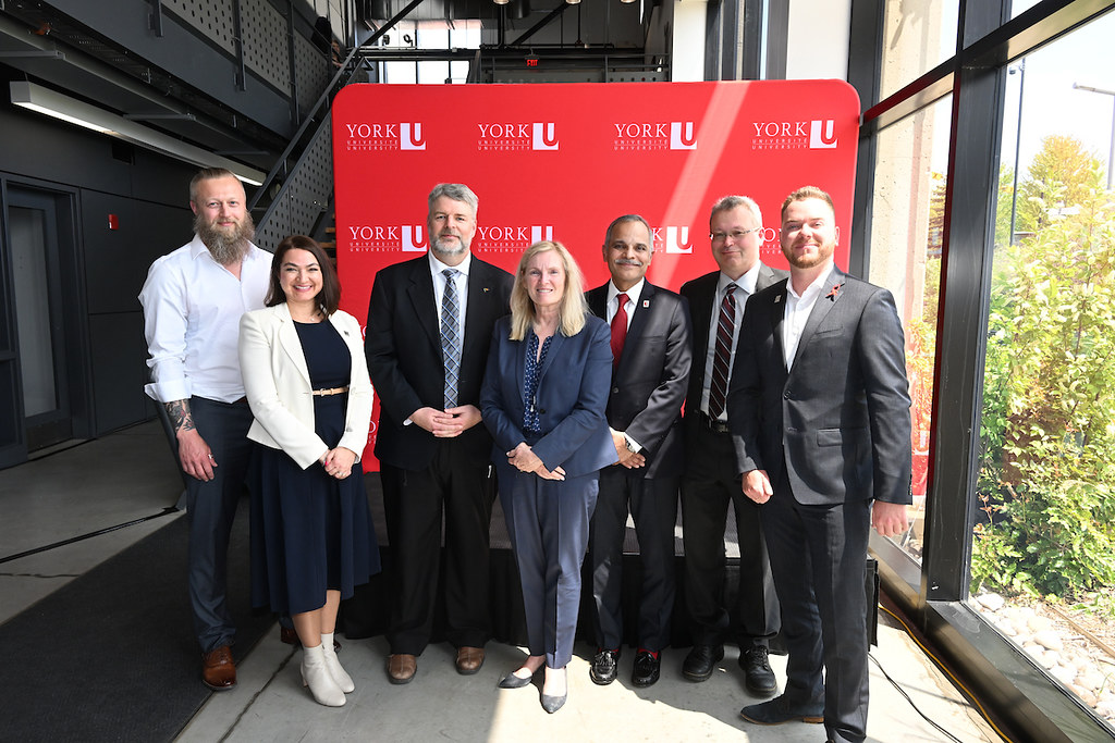 Picture in front of YorkU red logo wall at the CFREF celebration. In picture from left to right are: Vice Director Gunnar Blohm; Vice Director Pina D’Agostino, AVP Partnerships and Innovation Jim Banting, York President and Vice-Chancellor Rhonda Lenton, VP Research and Innovation Amir Asif, Scientific Director Doug Crawford, and Associate Director Sean Hillier.”
